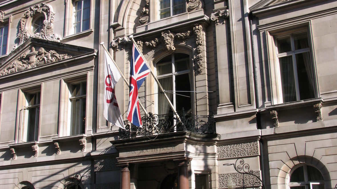 Georgian building Dartmouth House photographed on the road with blue sky and union jack flag