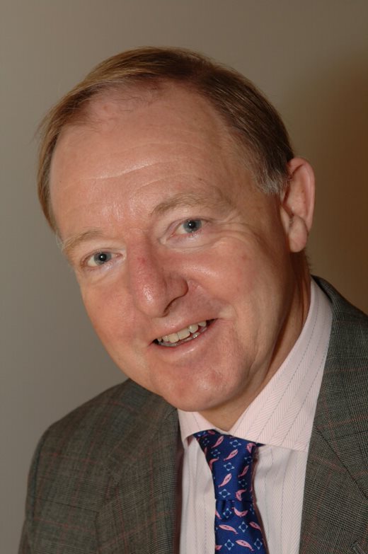 A man in a suit posing for a picture