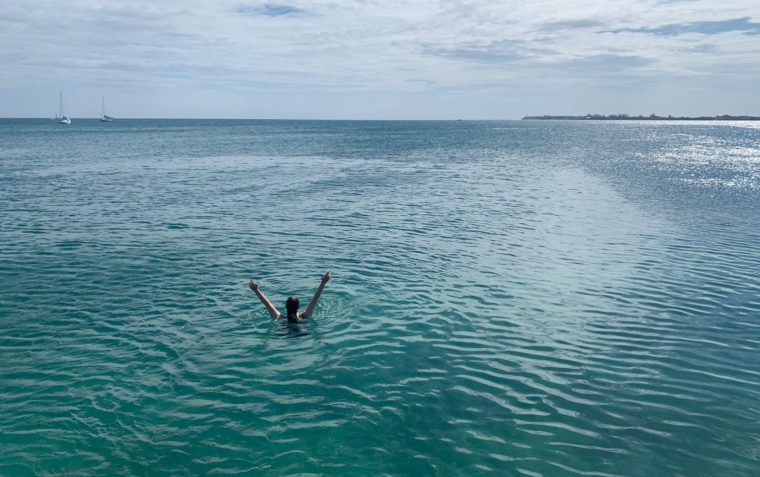Someone swimming in the beach